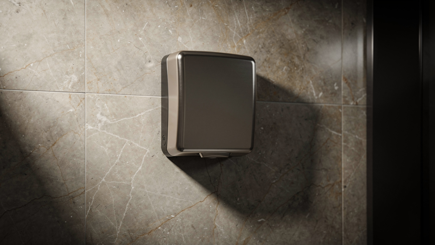 compact touch-free hand dryer in office bathroom